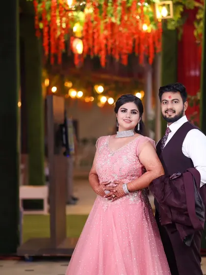A lovely couple portrait from an engagement party. The warm, festive lighting and their happy expressions perfectly capture the celebratory atmosphere.