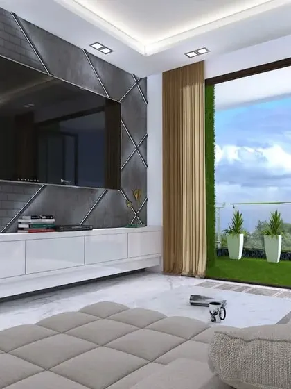 A modern living room in a Mumbai apartment with a textured TV wall and direct access to a green balcony.