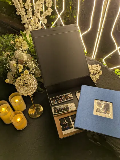 The complete package. Here you see the custom-monogrammed keepsake box, the beautiful linen album, and the collection of photo strips and prints ready to be explored.