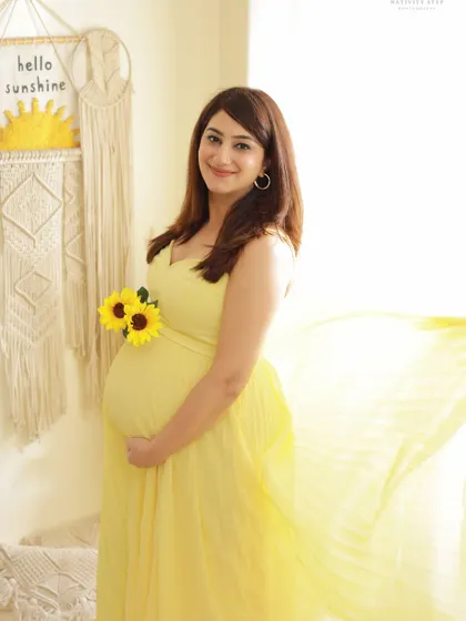 A bright and sunny solo portrait in our Boho studio. The yellow dress, sunflowers, and "Hello Sunshine" decor create a cheerful and optimistic vibe.