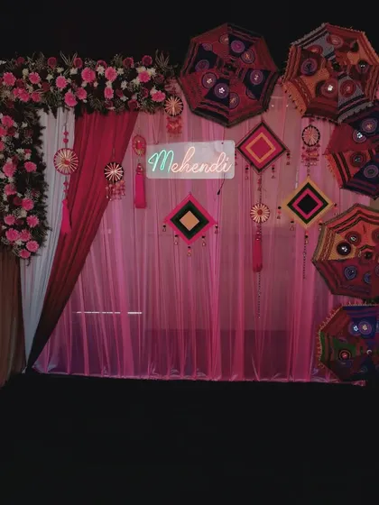 The complete Mehendi photo booth setup against a dark background, making the colors and lights pop.
