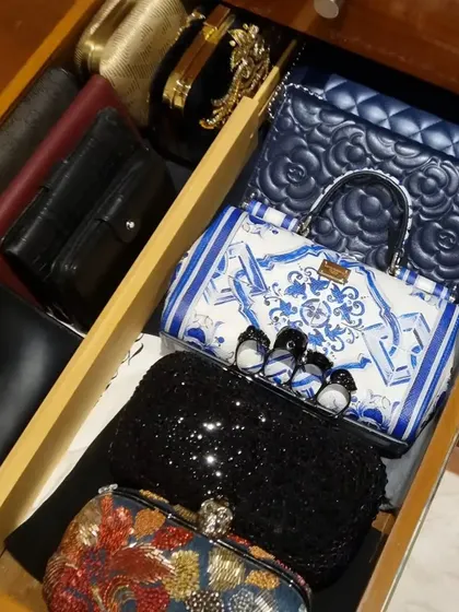 You don't need huge shelves to organize your clutches and small handbags. These images show how drawers with simple dividers can be the perfect home for your collection.