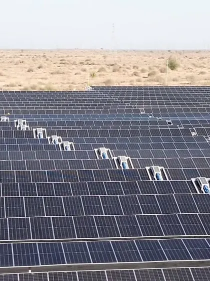 A close-up of the robotic cleaning systems deployed at Project JAI. This technology is crucial for maintaining panel efficiency in arid environments, ensuring consistent energy output and saving approximately 27 million liters of water annually.