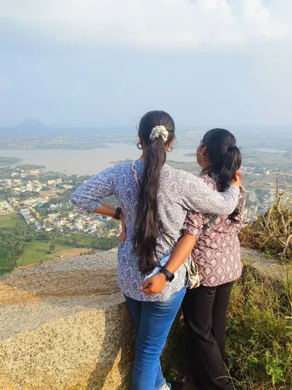 Two friends sharing a moment while looking out at the view. Travel is better when shared.