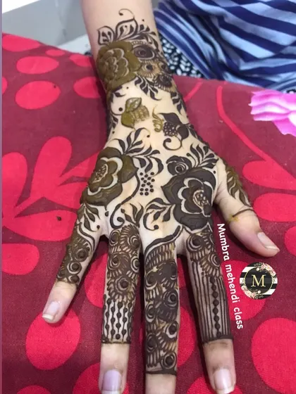 A floral design with detailed work on the fingers.