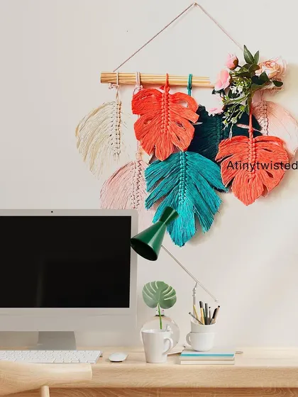 This monstera leaf wall hanging looks great in a home office, adding a splash of color and creativity above a desk.