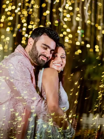 Playing with light to create something magical. This portrait uses creative lighting techniques to frame the couple in a cascade of golden bokeh, turning a simple embrace into a piece of art.