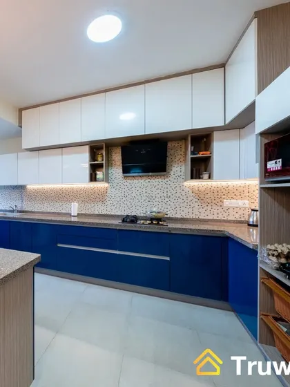 A stunning parallel kitchen with glossy blue base cabinets and white overhead units. The design maximizes storage and workspace while maintaining a sleek and uncluttered look.