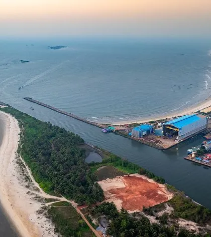 An aerial view of the Malpe Sea Walk and the entrance to the fishing harbour. This perspective shows the man-made structures shaping the natural coastline of Udupi.