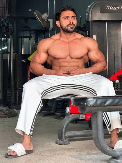A full shot, sitting on the bench.