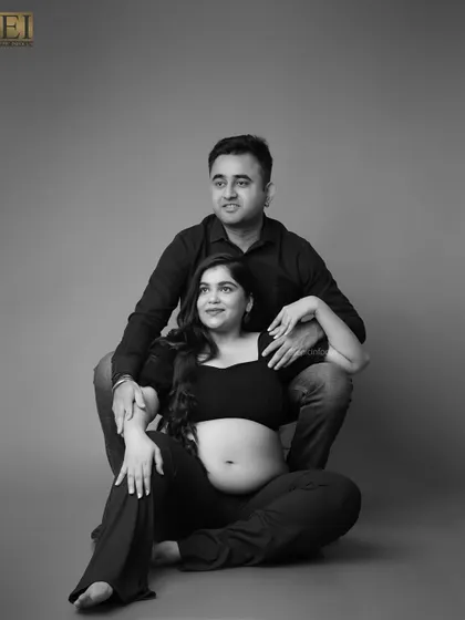 A modern black and white portrait of the couple seated together. This shot has a relaxed, contemporary feel.