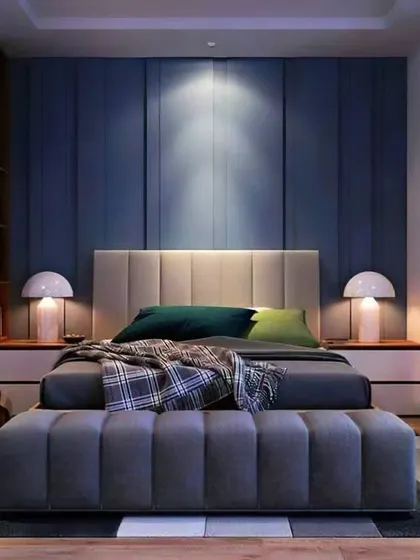 A cozy and modern bedroom design with a deep blue accent wall providing a sense of calm. The room includes a built-in wardrobe with a mirrored panel and an attached dressing table, making it a complete and functional space.