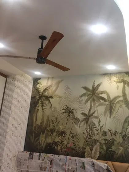 A beautiful tropical mural used as an accent behind the bed. The misty jungle scene adds depth and a sense of escape, enhanced by the surrounding textured wallpaper panels.