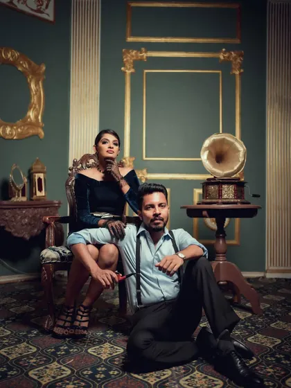 A stylish portrait from our vintage series, with the couple posed in a richly decorated room. The composition and mood are designed to feel like a still from a classic film.