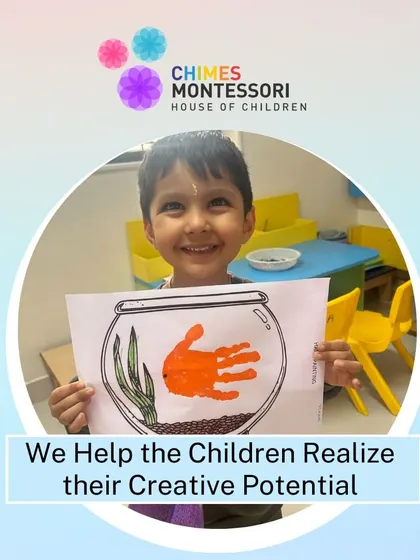 A child beams with pride as he holds up his finished handprint fish in a bowl, a testament to his creative potential.