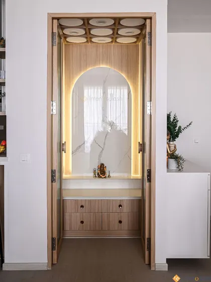 The same puja unit with the integrated backlighting turned on. The warm glow highlights the marble texture and creates a serene and divine ambiance for prayer.