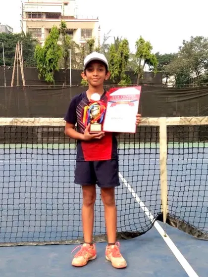 Another one of our promising young talents with his well earned trophy. We are proud to guide our junior players on their path to competitive success.