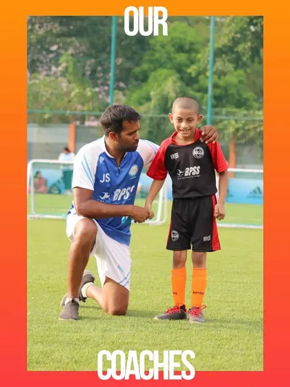 A coach offering words of encouragement to a young player. Our competition day is as much about learning as it is about winning.