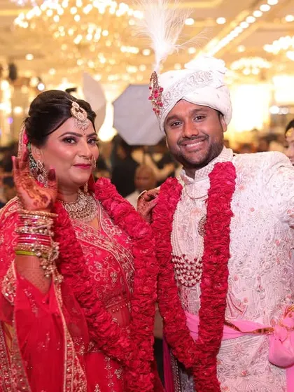 A celebratory shot of the happy couple after their Jaimala ceremony, surrounded by family and friends.