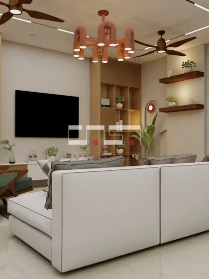 The "after" shot of a living room makeover, now a vibrant and stylish space with a unique chandelier, comfortable sofa, and plenty of natural textures.