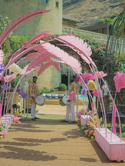 A unique entrance walkway made of large, pink feather-like structures. This creative and artistic element provides a stunning and memorable entry experience for guests.