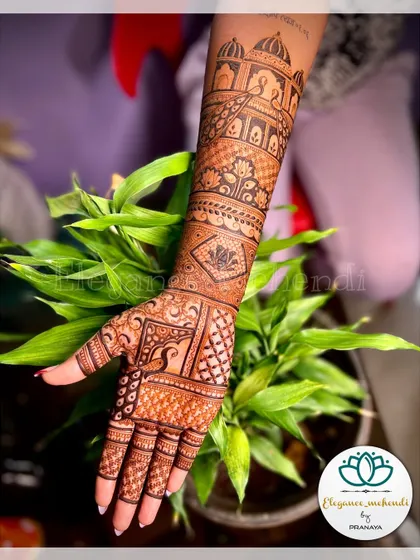A detailed bridal mehendi design featuring an architectural motif and a peacock on the hand.