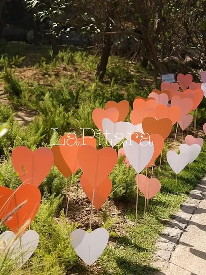 The pathway leading to the event was lined with dozens of pink, white, and red hearts, creating a whimsical and romantic welcome for guests.