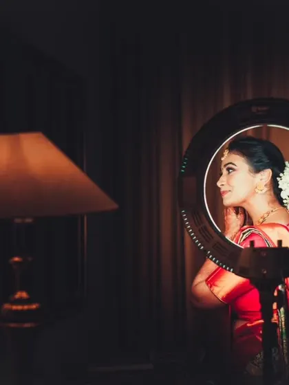 A creative use of a ring light to frame the bride's portrait as she gets ready, resulting in a unique and modern shot.