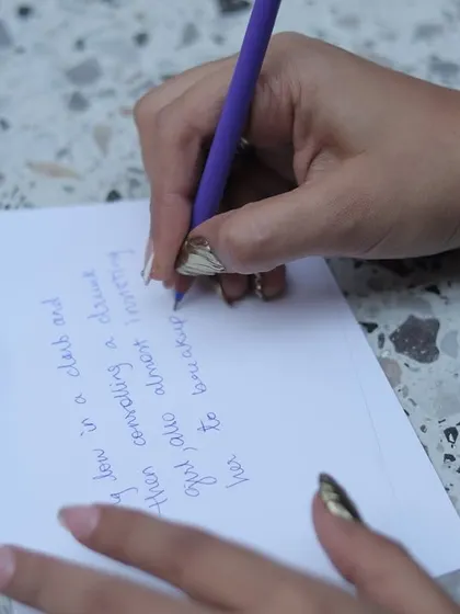 A guest writing down her heartfelt wishes and advice for the bride-to-be.