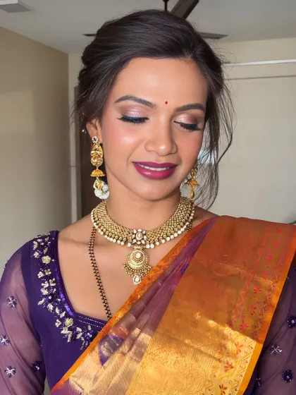 A close-up on the eye makeup for this traditional look. I used soft, shimmery lilac and pink tones on the lids to echo the colors in her saree, creating a cohesive and elegant effect.