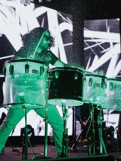 A water drummer performing on stage, a unique and visually stunning act that adds a 'wow' factor to any Sangeet.