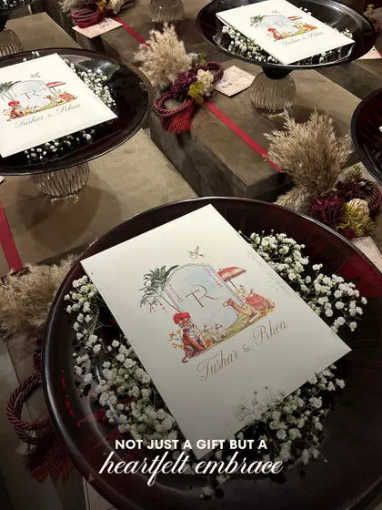 Not just a gift, but a heartfelt embrace. This image captures the beauty of the Crimson Crystal Bowl, holding a personalized card for a couple's special day, surrounded by rustic, dried florals.