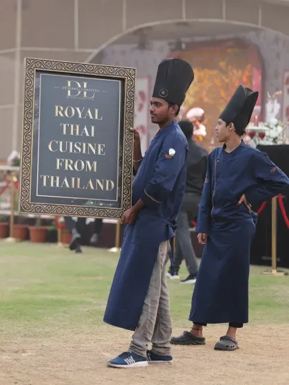 Our chefs carry the signage for the Royal Thai Cuisine station. This shows the mobile and adaptable nature of our setups, ready to create a unique food destination anywhere.