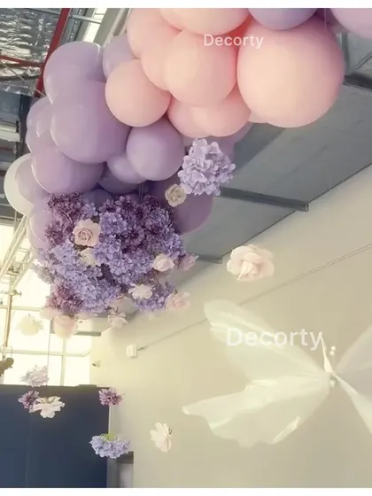 A view of the ceiling decor, where I created floating clouds of balloons with hanging floral arrangements to make the entire room feel enchanted.