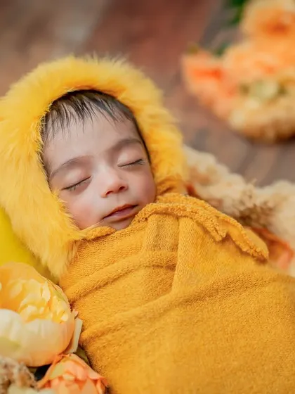 This angle shows the baby nestled among the props, giving a sense of warmth and comfort.