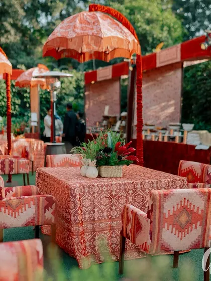 We used custom-printed textiles for the chairs and tablecloths in this outdoor seating area. Paired with ornate umbrellas, it creates a luxurious, bohemian vibe for guests to relax in.