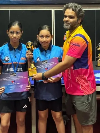 The girls doubles team with their trophies. It's great to see them succeed and grow as players together.