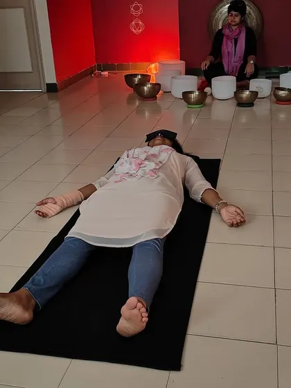 A participant rests in a state of deep relaxation during a practice sound bath. Learning to create and hold this safe, healing space is a cornerstone of my teacher training program.