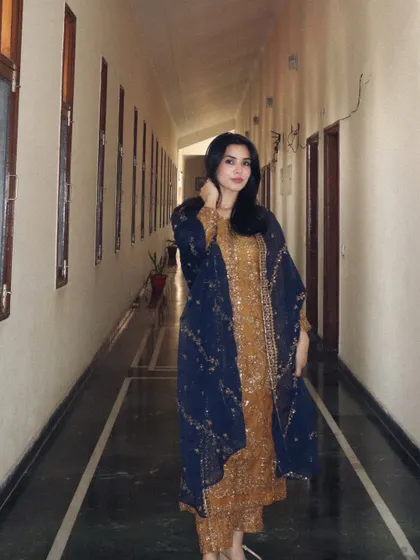 A final shot showcasing the complete Asim Jofa ethnic outfit in a long corridor.