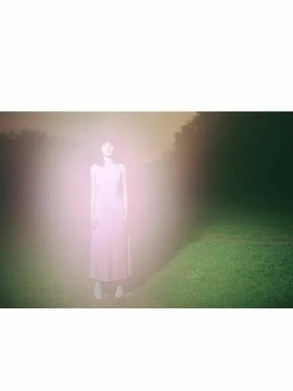 An experimental shot for Sruti Dalmia using a light flare effect. The styling is minimal, with the pink dress acting as a canvas for the ethereal, glowing light that envelops the model, creating a dreamlike and abstract fashion portrait.