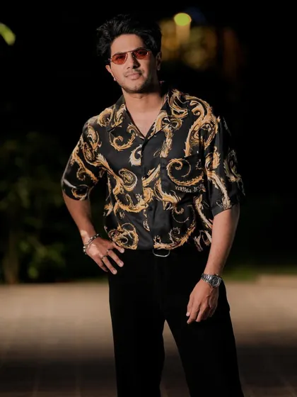 The full look. The iconic Versace print gives this outfit a dose of high-fashion energy, perfect for a promotional event.