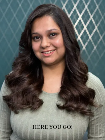 The final result of a color correction. We transformed brassy, uneven color into a rich, cool-toned brown with soft waves and a healthy shine.