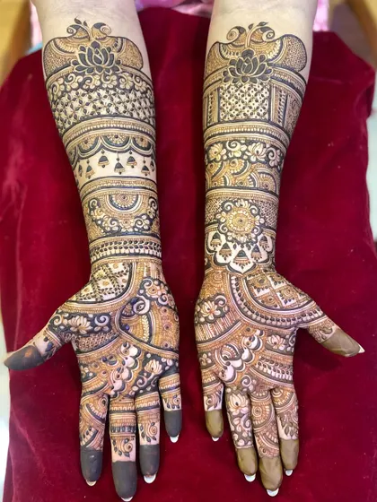 This design for an engagement features a mix of lotuses, checks, and flowing vines, covering the hands and arms in beautiful detail.