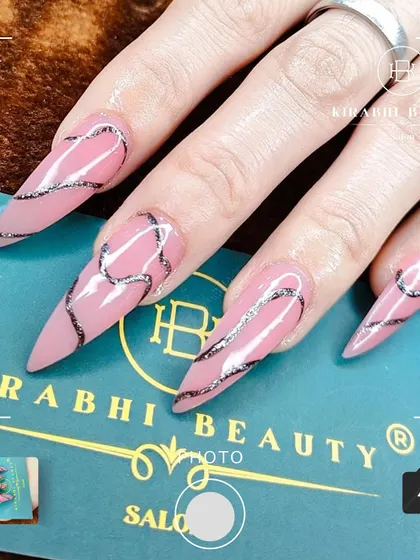 A close-up shot of the abstract silver swirl nail art, highlighting the texture and precision of the lines.