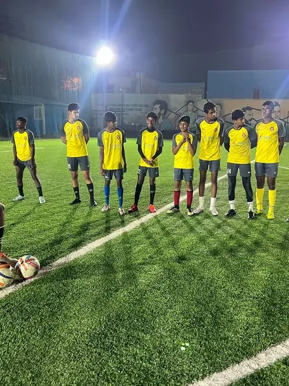 Coaching passion, fostering growth, and celebrating every goal. A coach stands with his team, ready to impart wisdom and strategy.