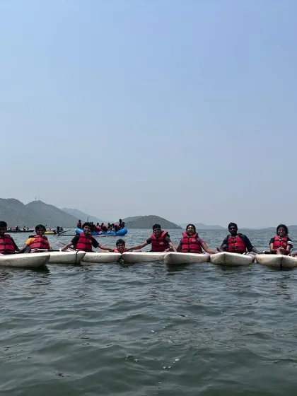 Participants in single kayaks hold onto each other, creating a stable line on the water. This is a great team-building exercise we use to help beginners get comfortable.