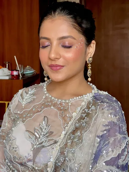 A close-up of the purple sparkle eye makeup. The glitter is strategically placed to catch the light and create a mesmerizing effect.