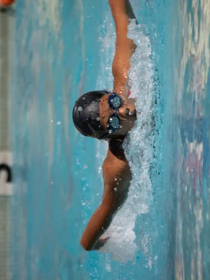 Perfecting the backstroke. This shot captures the precise body rotation and arm extension we teach to maximize power and speed in every stroke.