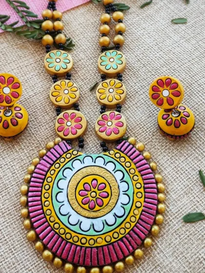 A pastel-toned floral mandala necklace in pink, mint, and yellow. This is a modern take on a traditional design, appealing to customers who prefer softer colors.