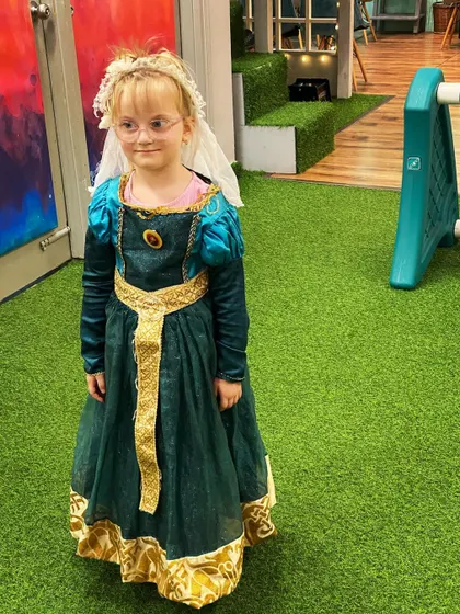 A little princess in a beautiful green and gold gown, ready for a royal ball or a fun party at Winkyboo. Pretend play is always encouraged here.